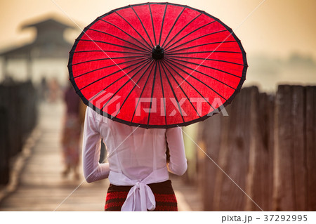 Myanmar Woman walking on the U Bein Bridge Myanmar Woman walking on the U Bein Bridge 37292995