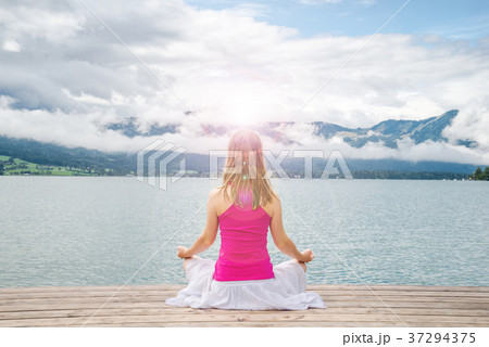Woman meditating at the lake 37294375