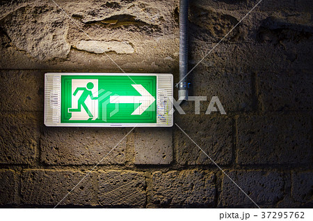 emergency exit light green sign on brick wall in emergency exit light green sign on brick wall in 37295762