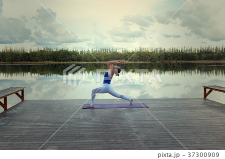 A lively young woman exercise with lush yoga A lively young woman exercise with lush yoga 37300909