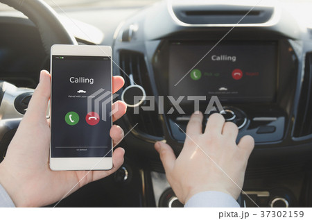 Man using phone calling system in car Man using phone calling system in car 37302159
