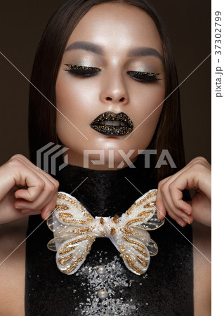Beautiful girl with black creative art make-up and Beautiful girl with black creative art make-up and 37302799