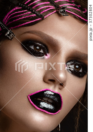 A beautiful girl with a black creative make-up and 37302804