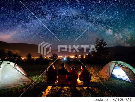 Silhouette of people sitting in the camp in night 37306024