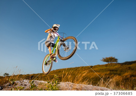 Cyclist riding downhill on mountain bike on the hill Cyclist riding downhill on mountain bike on the hill 37306685
