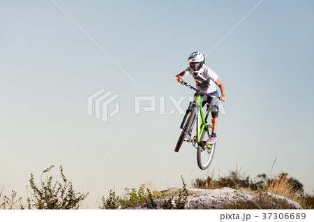Cyclist riding downhill on mountain bike on the hill Cyclist riding downhill on mountain bike on the hill 37306689