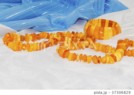 Amber necklace on a light blue background, jewelry Amber necklace on a light blue background, jewelry 37306829