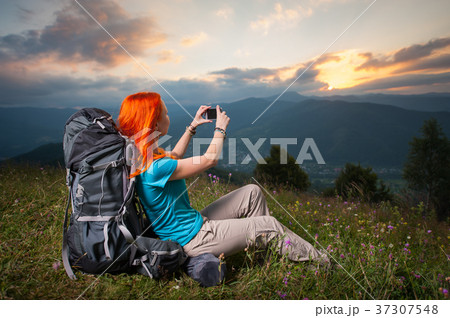 Happy female hiker traveling in the mountains 37307548