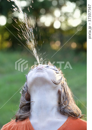 Boy Fooling Around Squirting Water 37307567