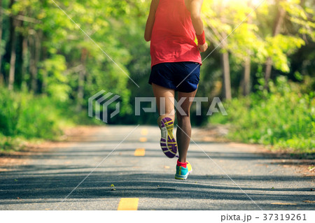 woman runner running on tropical forest trail 37319261