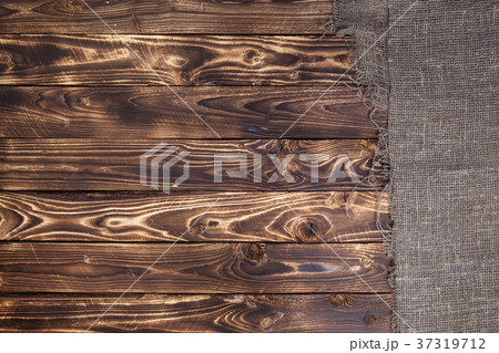 Burlap on dark wooden background 37319712