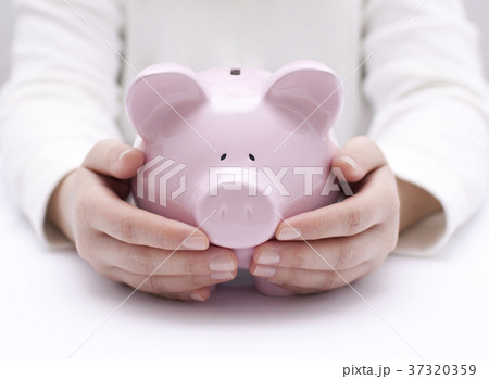 Piggy bank protected by hands Piggy bank protected by hands 37320359