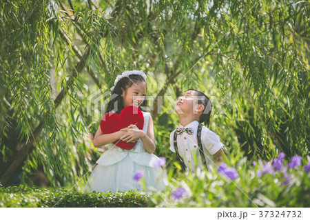 Little kids holding heart valentine pillow Little kids holding heart valentine pillow 37324732