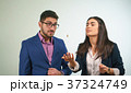 Business partners throw a coin a girl is surprised 37324749