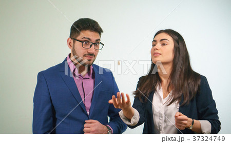 Business partners throw a coin a girl is surprised 37324749