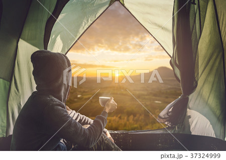 Young woman traveler sitting in the tent 37324999