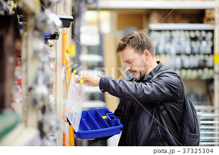 man choosing the right tool box in a store man choosing the right tool box in a store 37325304