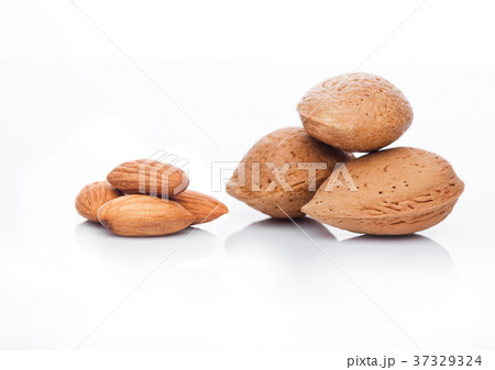 Raw almonds nuts with shell on white background Raw almonds nuts with shell on white background 37329324