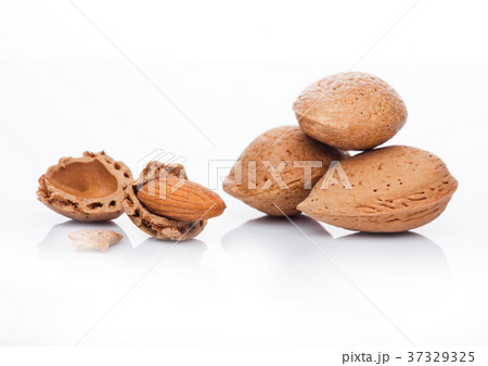 Raw almonds nuts with shell on white background Raw almonds nuts with shell on white background 37329325