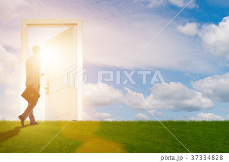 Businessman standing in front of door into future Businessman standing in front of door into future 37334828