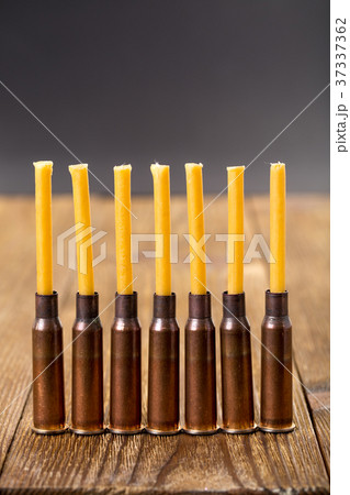 Candles and empty rifle cartridges. 37337362