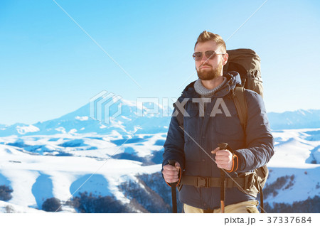A hipster traveler with a beard wearing sunglasses 37337684