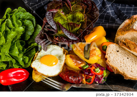 Baked potatoes and sausage with roasted vegetables Baked potatoes and sausage with roasted vegetables 37342934