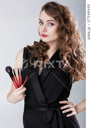 woman make-up artist with natural make-up holding woman make-up artist with natural make-up holding 37346449
