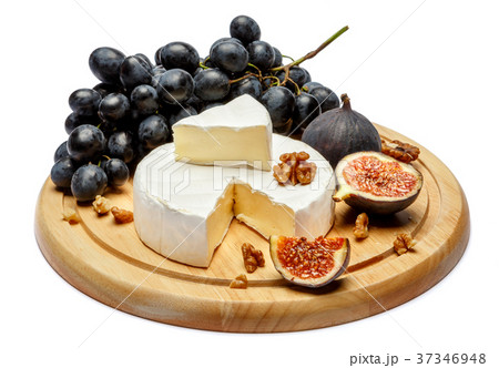 Round brie or camambert cheese on cutting board 37346948