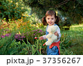 beautiful little girl eats candy. 37356267