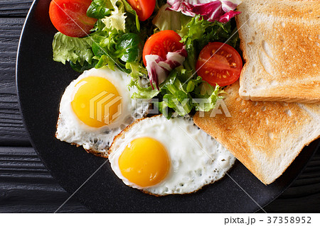 breakfast of fried eggs with fresh vegetable 37358952