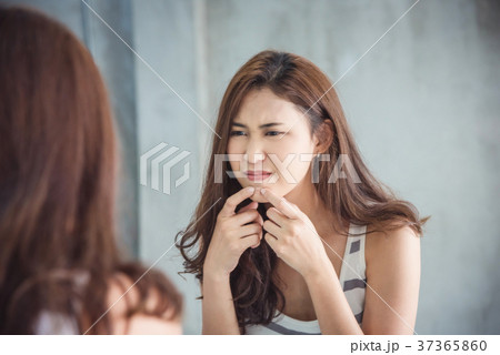 Woman squeeze her pimple in bathroom 37365860