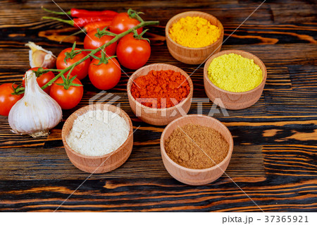 Various spices and herbs on wooden table. Various spices and herbs on wooden table. 37365921