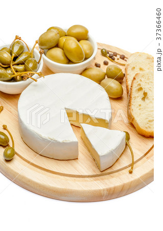 Round brie or camambert cheese on cutting board 37366460