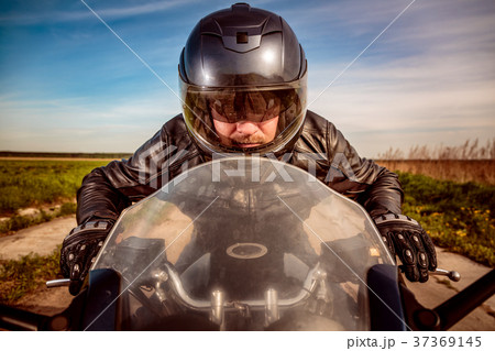 Biker racing on the road 37369145