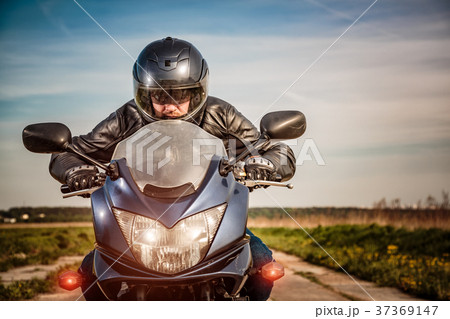 Biker racing on the road 37369147