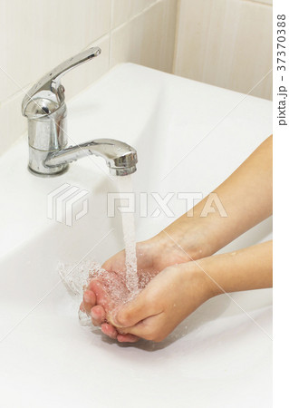 Washing of hands with soap under the crane with 37370388
