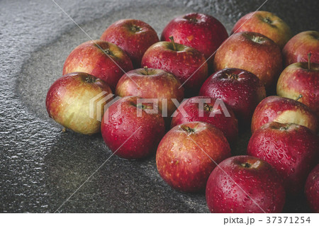 Wet apples on a granite rock in the rain 37371254