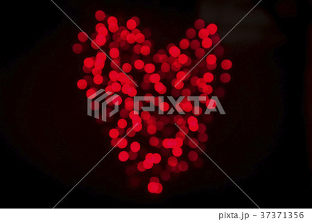 Heart made of shiny bokeh lights in red color 37371356