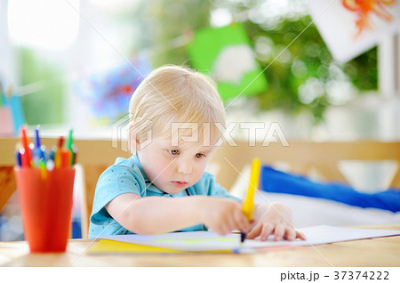 Cute little boy drawing and painting with colorful markers pens at kindergarten Cute little boy drawing and painting with colorful markers pens at kindergarten 37374222