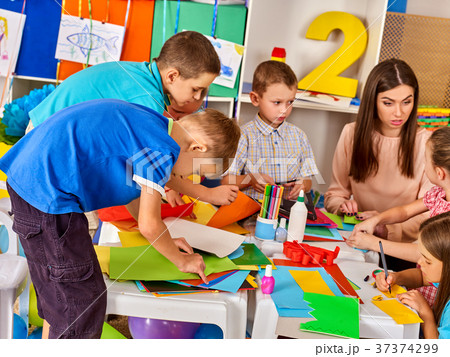 School children with scissors and cutting color School children with scissors and cutting color 37374299