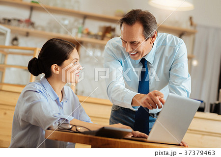 Pleasant senior man standing and working with a 37379463