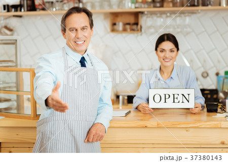 Pleasant intelligent man smiling and stretching Pleasant intelligent man smiling and stretching 37380143