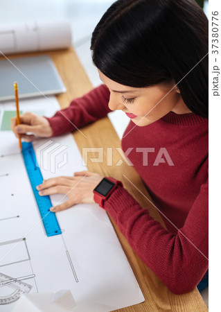 Careful engineer smiling and drawing a neat line 37380776