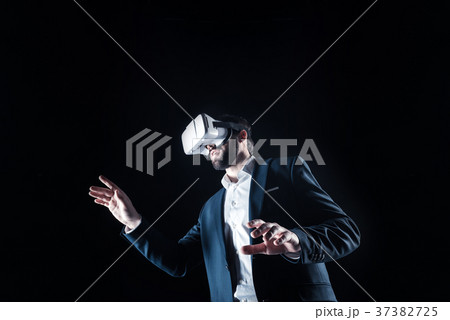 Handsome smart man using virtual reality glasses Handsome smart man using virtual reality glasses 37382725