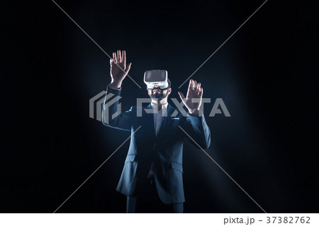 Handsome serious man pressing his hands to the Handsome serious man pressing his hands to the 37382762