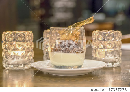 coffee in a glass in a glass plate whipped cream coffee in a glass in a glass plate whipped cream 37387278