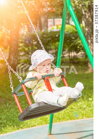 The baby is swinging on the swing The baby is swinging on the swing 37387914