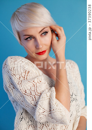 Portrait of blonde with short hair on a blue 37390238