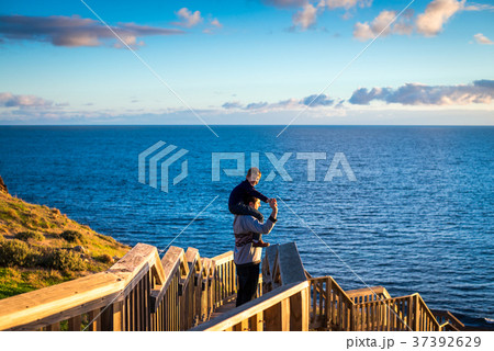 Father giving his son piggyback ride  37392629